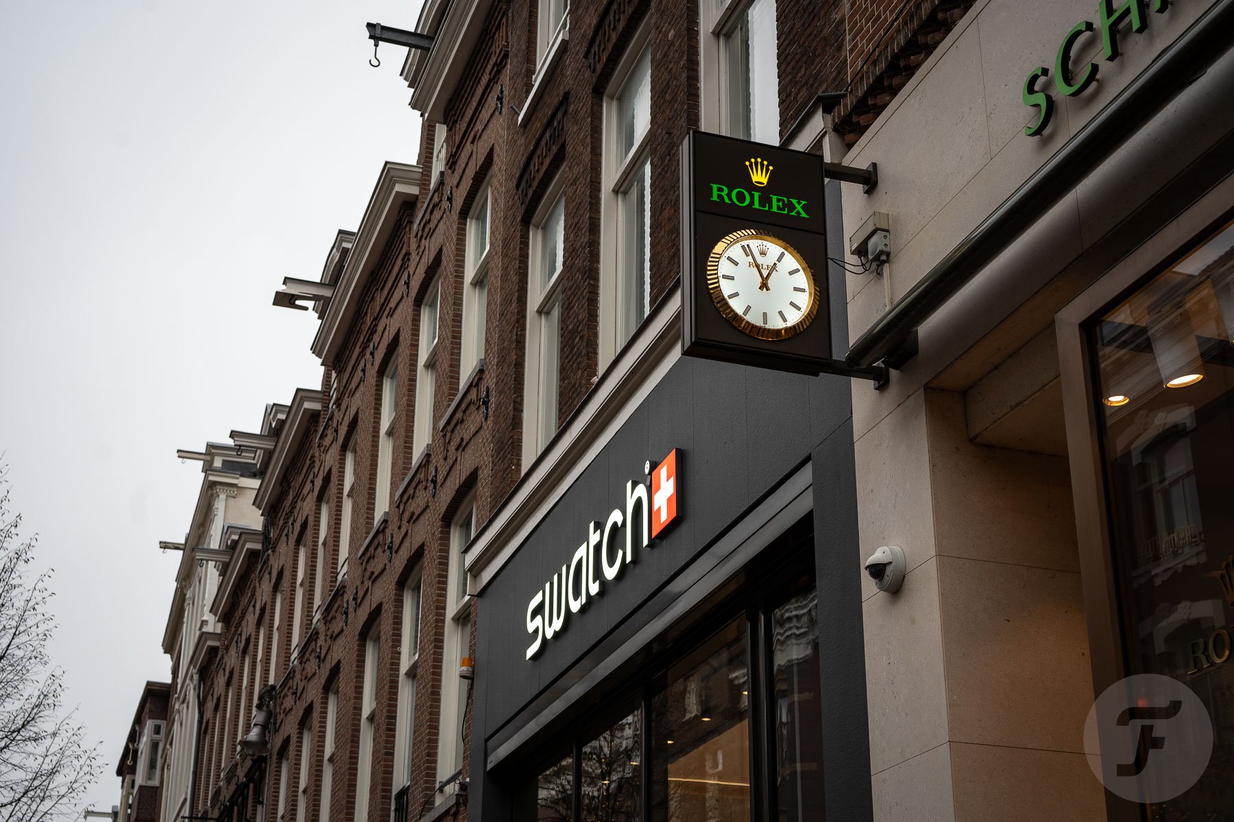 watch branding — Rolex clock and Swatch boutique